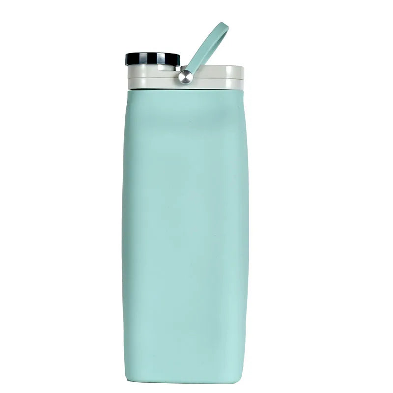 Collapsible silicone water bottle in blue, folded for compact storage.
