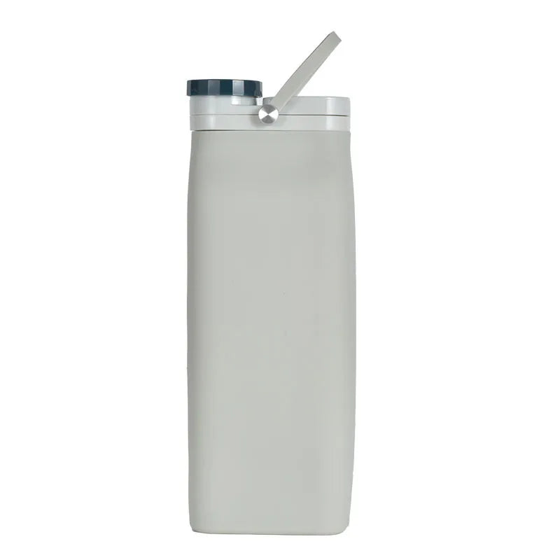 Collapsible silicone water bottle in white, folded for compact storage.
