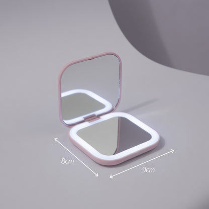 Compact mirror with dimensions on a gray background