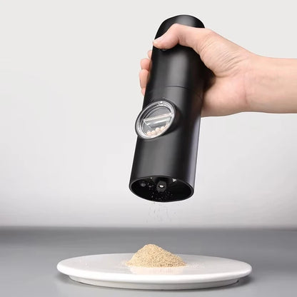 Black pepper grinder being used to sprinkle pepper onto a plate with a white background