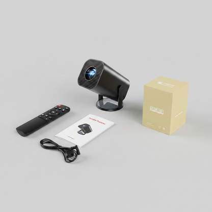Black projector with remote control, cable, and user manual on a gray surface