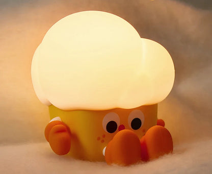 Cute cartoon crab night light emitting soft warm light on a soft surface.
