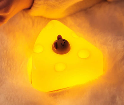 Cheese-shaped night light with a small brown mouse figure on a soft, beige background.