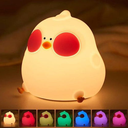 Chicken-shaped night light with color-changing options on a dark background