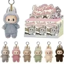 Collection of Labubu dolls keychains in various colors with a display box in the background.