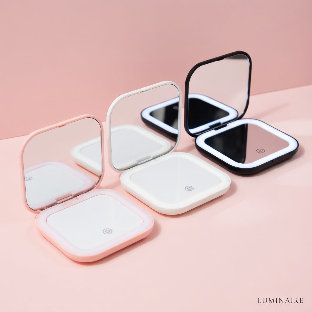 pocket size led mirrors in three colors, Foldable mirrors with LED lights on a pink background,