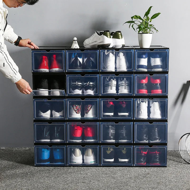 Multiple transparent shoe storage boxes stacked neatly for space-saving organization.
