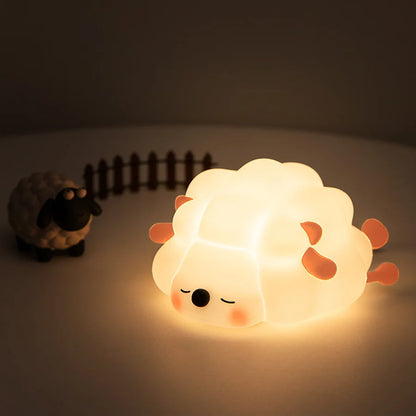 Sheep-shaped night light glowing on a dark background